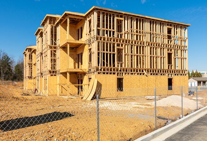 a close-up of temporary chain link fences enclosing a construction site, signaling progress in the project's development in Rush, NY